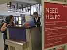 A Delta Airlines agent assists a woman at JFK International Airport in New York.