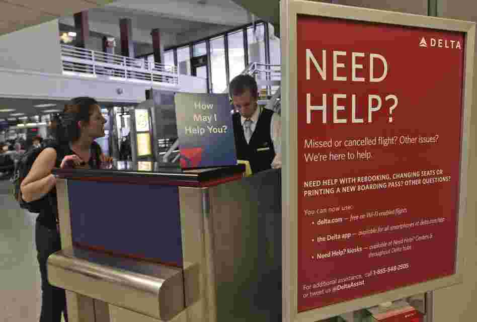 A Delta Airlines agent assists a woman at JFK International Airport in New York.
