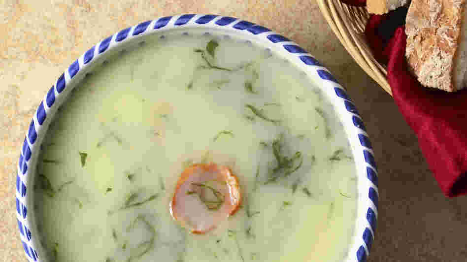 Caldo Verde, a traditional Portuguese soup of potatoes, greens and onions, garnished with a slice of chourico sausage.