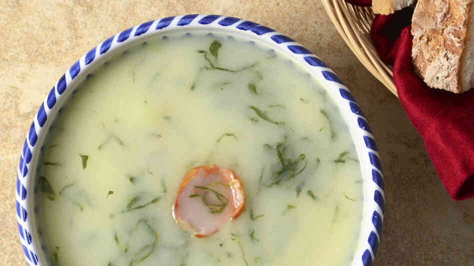 Caldo Verde, a traditional Portuguese soup of potatoes, greens and onions, garnished with a slice of chourico sausage.