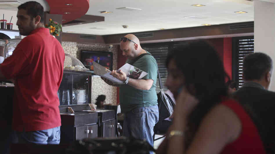 Palestinians order food at a coffee shop in the West Bank city of Ramallah on Sunday.