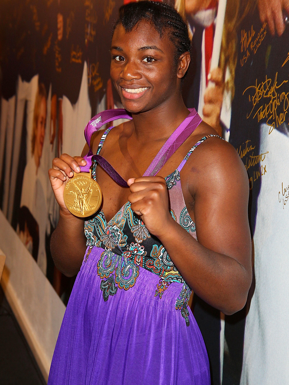 Olympian Claressa Shields visits the USA House in London before leaving for her home in Flint, Mich. Shields was greeted by a marching band and a motorcycle escort in her hometown.