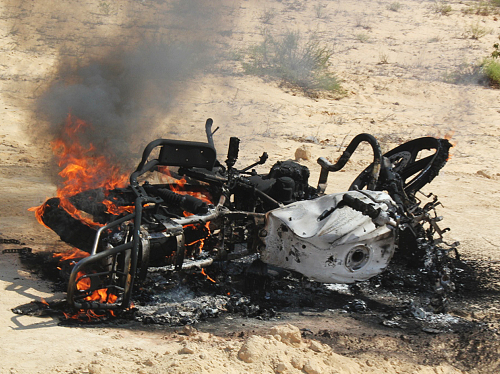 A motorbike burns following a raid by Egyptian security forces on the village of El-Jurah in Egypt's North Sinai province on Aug. 12. Six gunmen were killed in the raid.