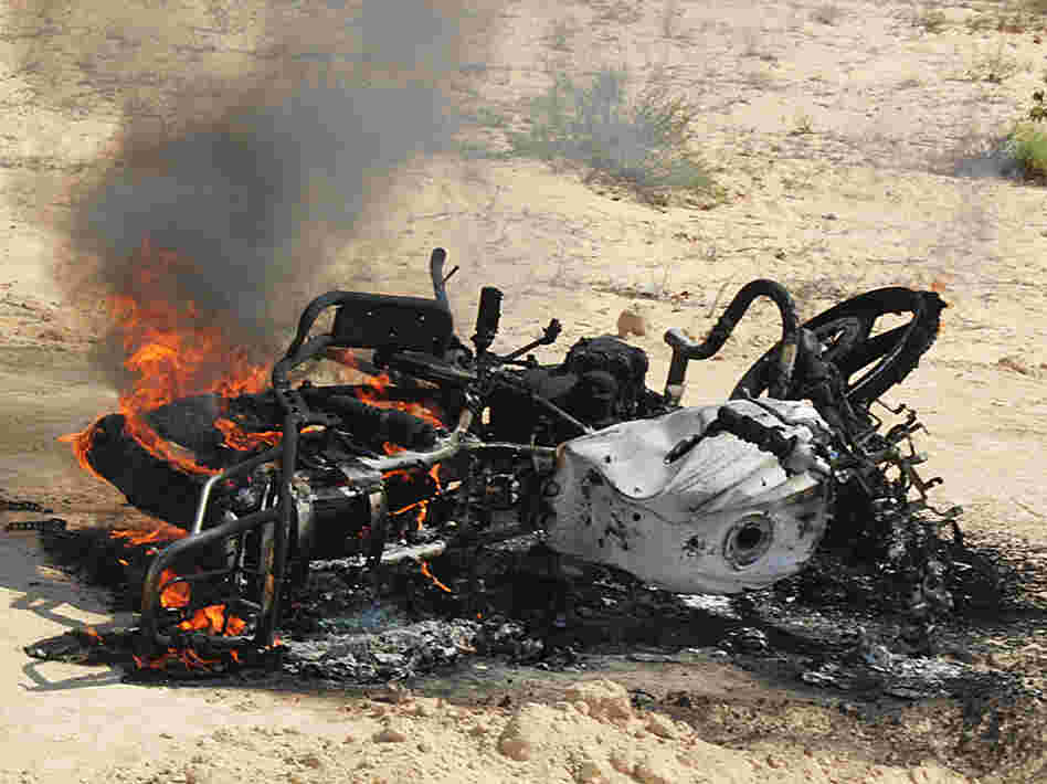 A motorbike burns following a raid by Egyptian security forces on the village of El-Jurah in Egypt's North Sinai province on Aug. 12. Six gunmen were killed in the raid.
