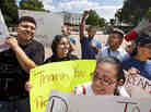 Ricky Campos, 23, and Katye Hernandez, 22, both illegal immigrants from El Salvador who live in Silver Spring, Md., hold signs saying "Thank You President Obama" after he announced the new policy in June.