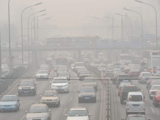 Vehicles make their way along a road on a smoggy day in Beijing on January 18, 2011. Beijing's government bowed to a vocal online campaign for a change in the way air quality is measured in the Chinese capital, one of the world's most polluted cities.