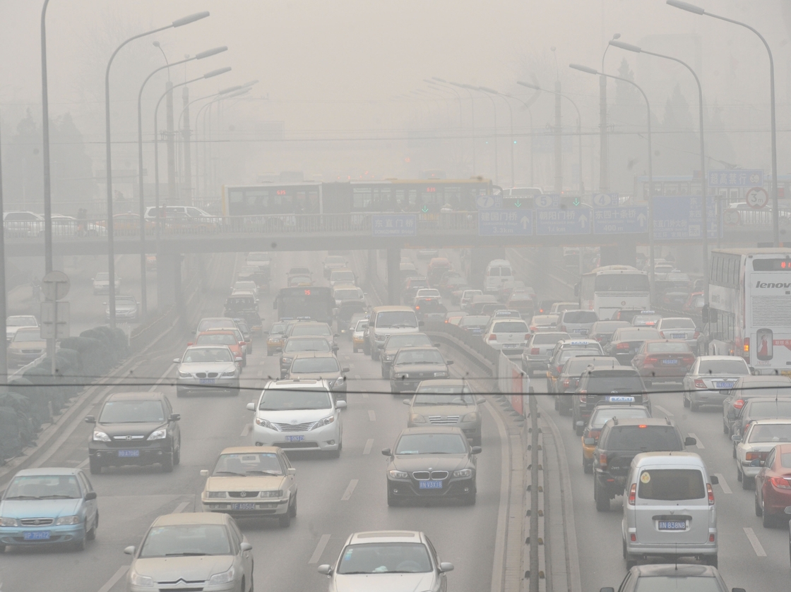 Vehicles make their way along a road on a smoggy day in Beijing on January 18, 2011. Beijing's government bowed to a vocal online campaign for a change in the way air quality is measured in the Chinese capital, one of the world's most polluted cities.