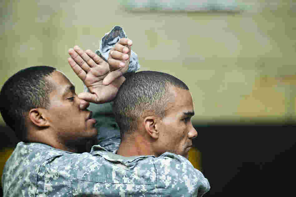 Sgt. 1st Class Isaac Cunningham (left) and Staff Sgt. Robert Terry practice maneuvers.