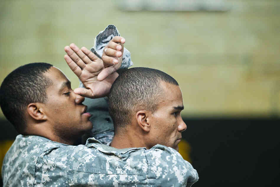 Sgt. 1st Class Isaac Cunningham (left) and Staff Sgt. Robert Terry practice maneuvers.