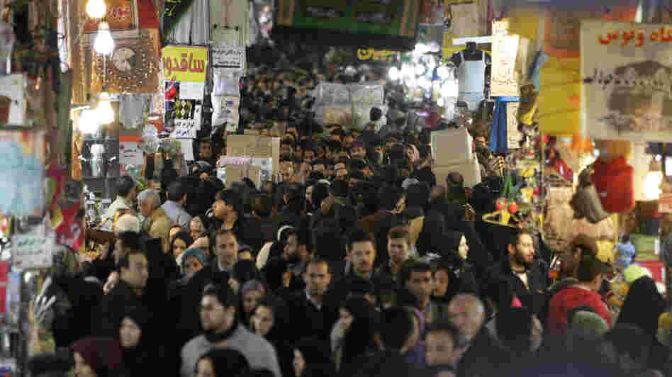 Iranians walk through the main bazaar in Tehran in January. Sanctions by the EU and U.S., plus political woes related to the Syrian uprising, have created the most serious crisis faced by Tehran since the 1980s.