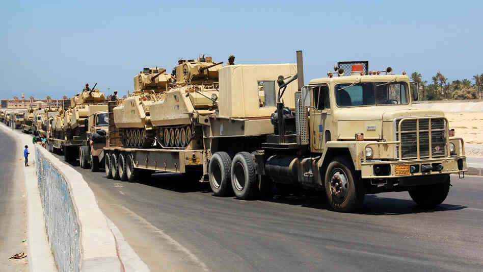 Army trucks carry Egyptian military tanks in El Arish, in the northern Sinai Peninsula, on Aug. 9. Security forces are conducting a major security campaign in the area after a deadly attack by masked gunmen on a border post left 16 soldiers dead. Army trucks carry Egyptian military tanks in El Arish, in the northern Sinai Peninsula, on Aug. 9. Security forces are conducting a major security campaign in the area after a deadly attack by masked gunmen on a border post left 16 soldiers dead.