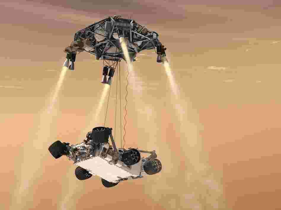 An artist's rendering shows a rocket-powered descent stage lowering the one-ton Curiosity rover to the Mars surface.