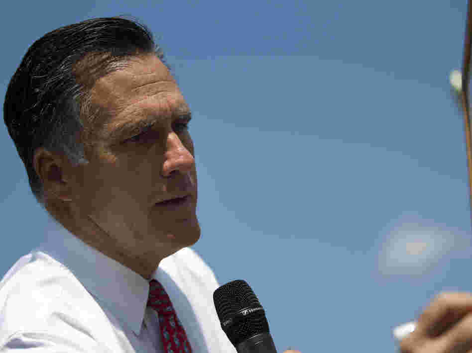 Republican presidential candidate Mitt Romney writes on a whiteboard during a news conference Thursday in Greer, S.C.