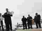 Dallas Mayor Mike Rawlings, center, holds a news conference in front of a plane that will be used for aerial spraying in Dallas.