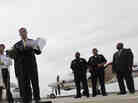 Dallas Mayor Mike Rawlings, center, holds a news conference in front of a plane that will be used for aerial spraying in Dallas.