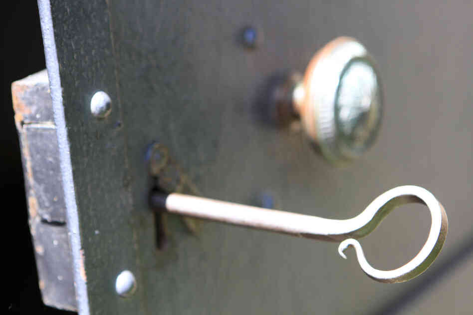 An old iron key unlocks the public vault on the cemetery grounds. 