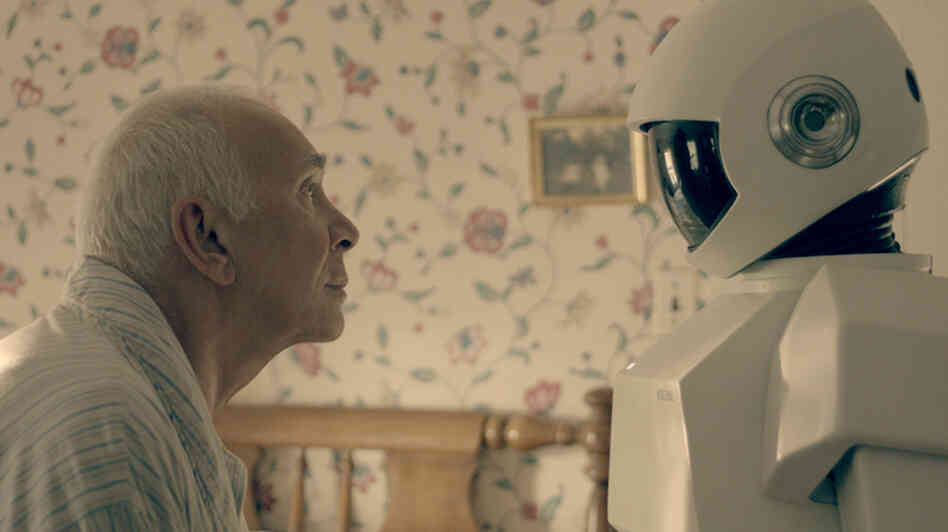 In Robot & Frank, a robot cares for an aging ex-burglar who has dementia. Frank Langella, who plays the burglar, says his character "becomes fond of the robot only because it is a tool for his wicked, wicked ways." In Robot & Frank, a robot cares for an aging ex-burglar who has dementia. Frank Langella, who plays the burglar, says his character "becomes fond of the robot only because it is a tool for his wicked, wicked ways."