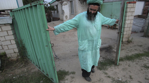 Gumar Ganiyev opens the gates of the compound where members of the Islamic sect he belongs to have lived in seclusion since the early 2000s outside Kazan, capital of the Russian province of Tatarstan, earlier this month.