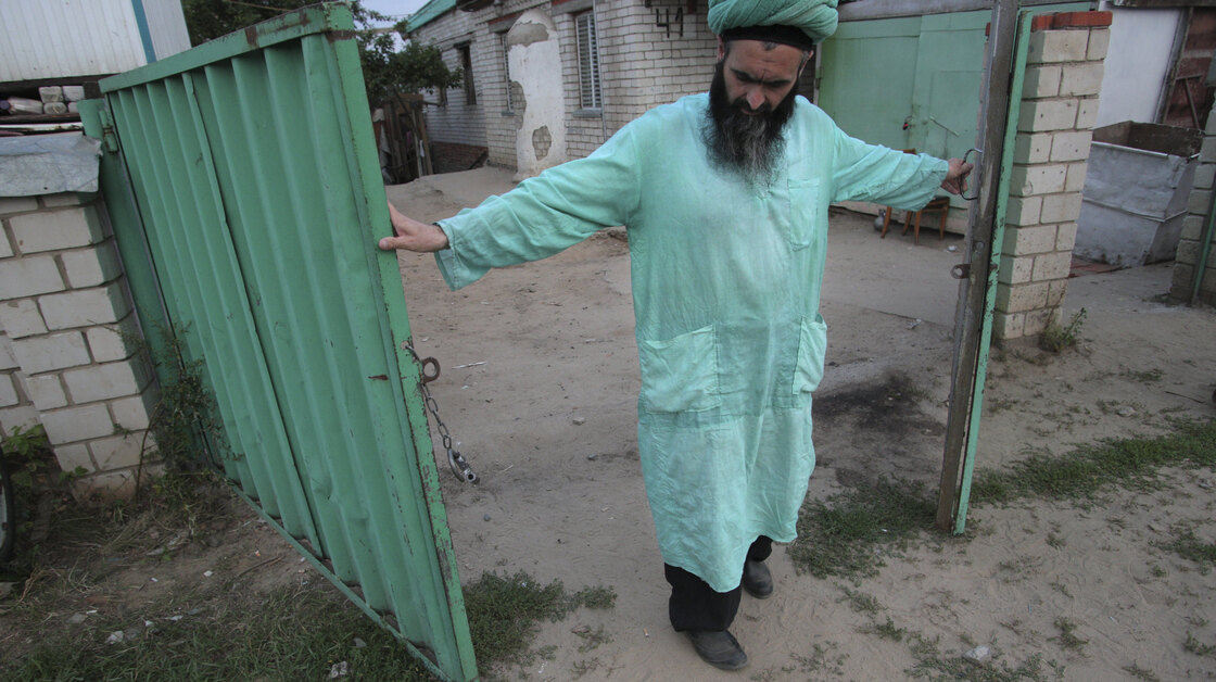 Gumar Ganiyev opens the gates of the compound where members of the Islamic sect he belongs to have lived in seclusion since the early 2000s outside Kazan, capital of the Russian province of Tatarstan, earlier this month.