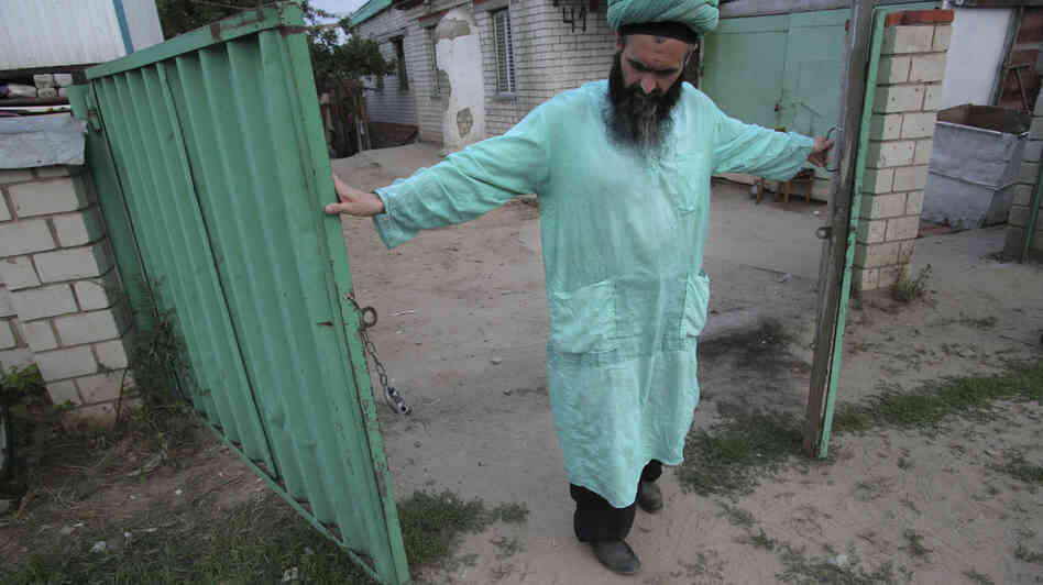 Gumar Ganiyev opens the gates of the compound where members of the Islamic sect he belongs to have lived in seclusion since the early 2000s outside Kazan, capital of the Russian province of Tatarstan, earlier this month.