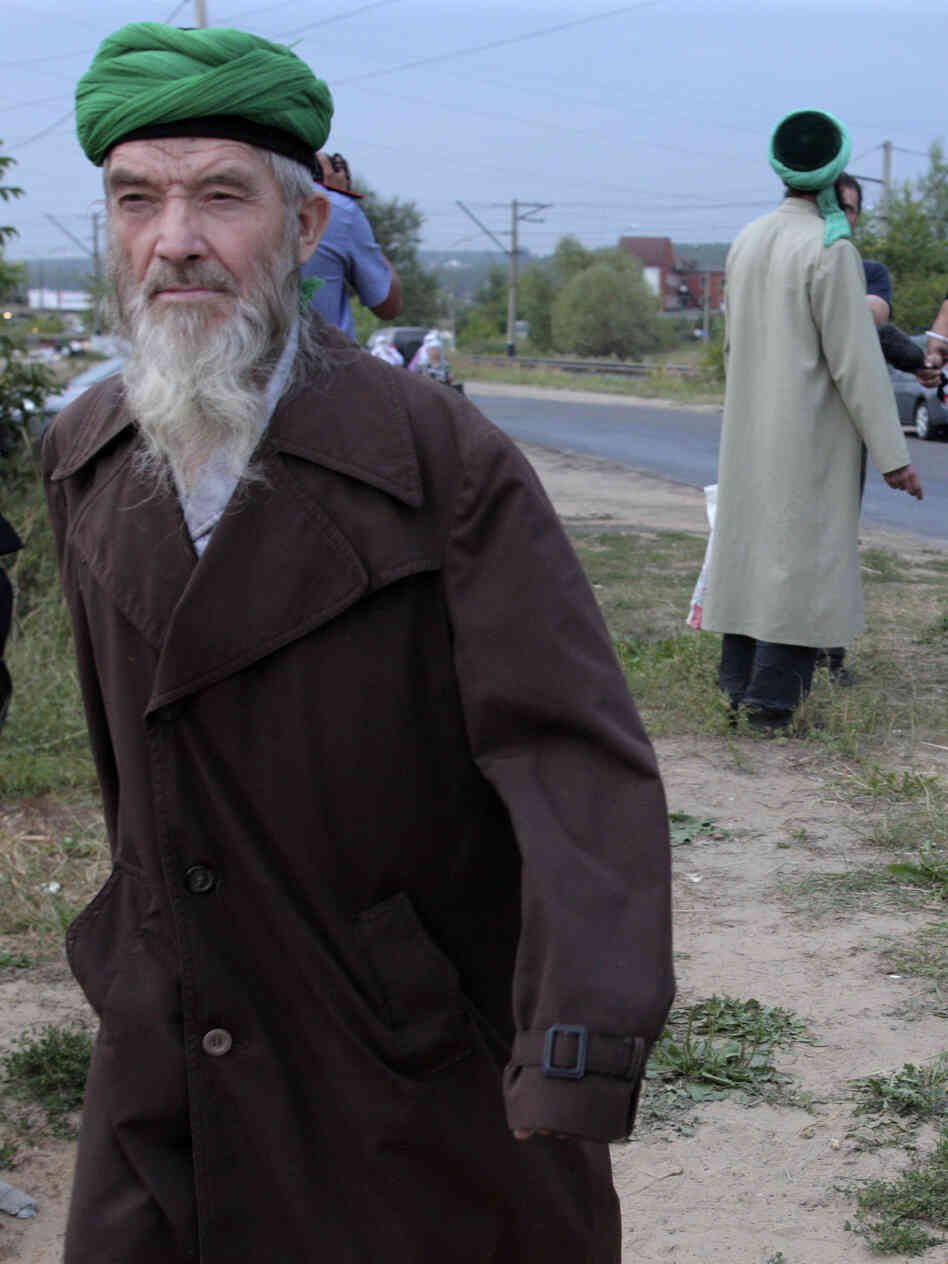 Self-proclaimed "messenger of God" Faizrakhman Satarov approaches the Kazan house earlier this month. The sect's founder says he had a revelation from God that true Muslims must separate themselves from society.