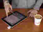 A barista processes a customer's payment using Square, a device that turns a mobile device into a card swiper. More businesses are using the devices to simplify credit card payments. Others are embracing technology that allows consumers to pay with their cellphones.