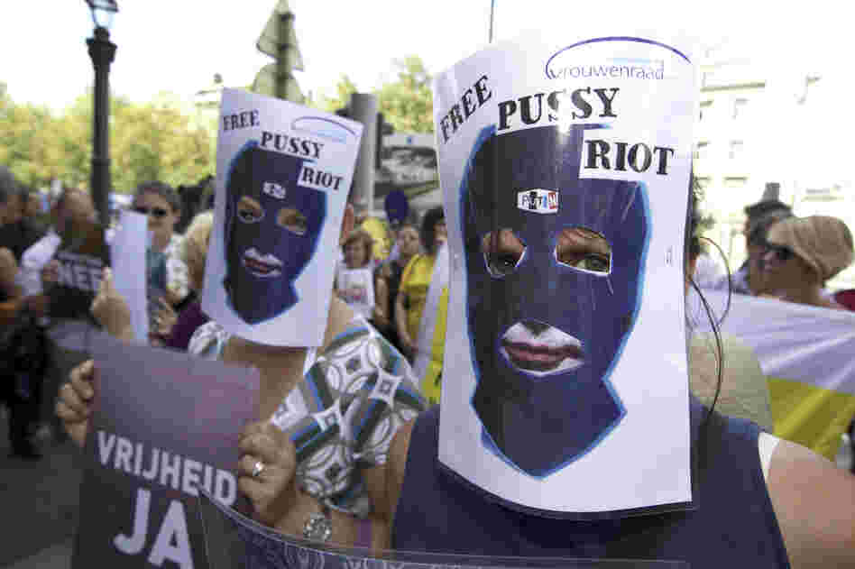 Demonstrators at a protest in Brussels wear paper masks in support of the band. 