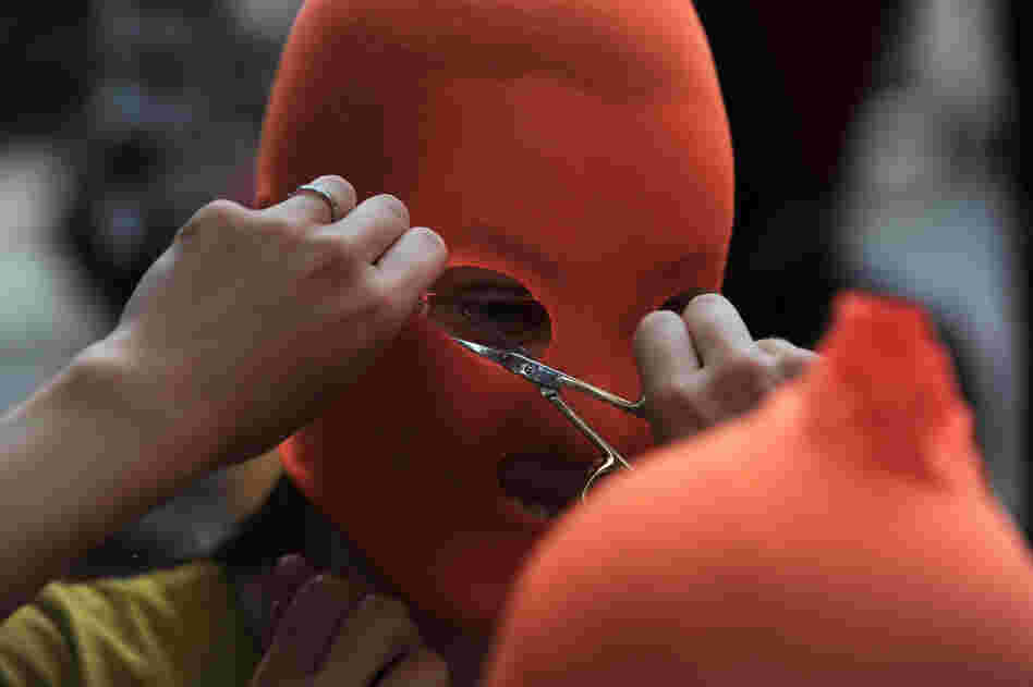 Pussy Riot supporters make masks near the Russian Embassy in London.