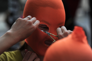 Pussy Riot supporters make masks near the Russian Embassy in London.
