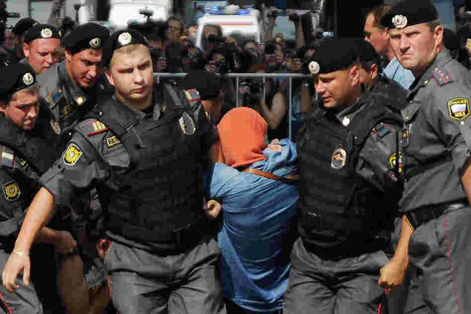 Russian policemen quell riots in Moscow.