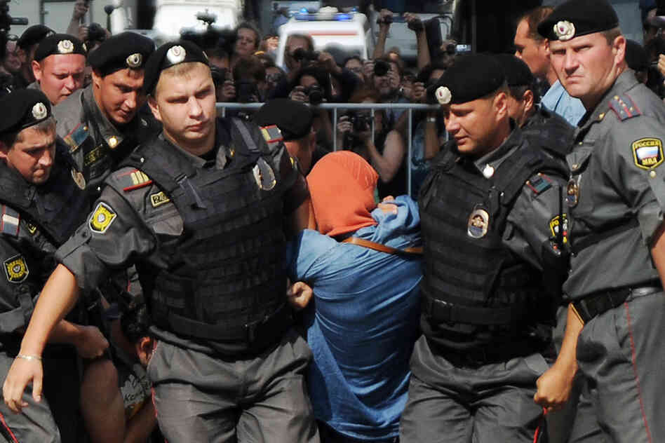 Russian policemen quell riots in Moscow.