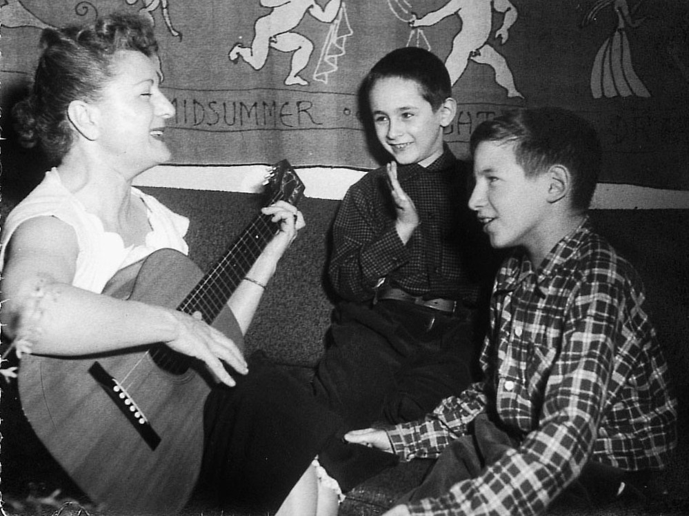 Anne Meeropol plays a song on guitar for her sons, Robert and Michael.