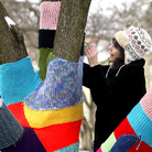 Nancy Mellon sews another knitted section to the "Knit Knot Tree" on Xenia Avenue in Yellow Springs, Ohio, in February 2008.