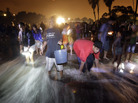 People stand on the beach to catch grunion during the annual grunion run at Cabrillo Beach in San Pedro, Calif., in 2009. People stand on the beach to catch grunion during the annual grunion run at Cabrillo Beach in San Pedro, Calif., in 2009.