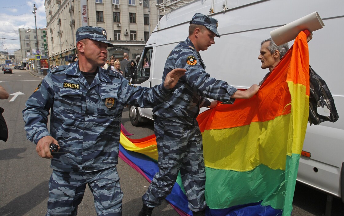 Russian police officers detain a gay rights activist with his flag during an attempt to hold a gay pride parade in Moscow in May.