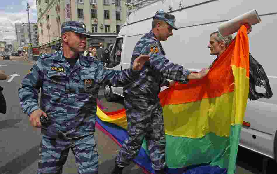 Russian police officers detain a gay rights activist with his flag during an attempt to hold a gay pride parade in Moscow in May.