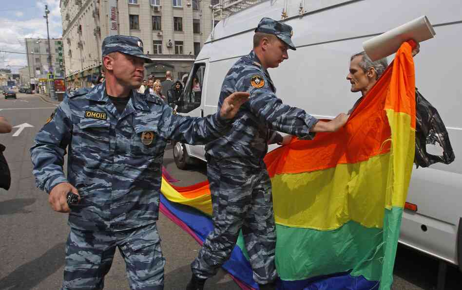 Russian police officers detain a gay rights activist with his flag during an attempt to hold a gay pride parade in Moscow in May.