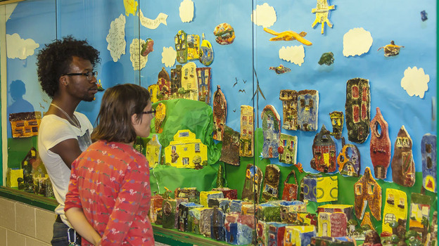 Checking out a wall display of art from the Claymobile.