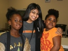 Austin College student Naureen Dharani, center, with new friends at an afterschool program. Austin College student Naureen Dharani, center, with new friends at an afterschool program.