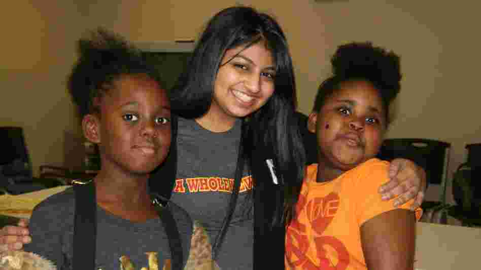 Austin College student Naureen Dharani, center, with new friends at an afterschool program.