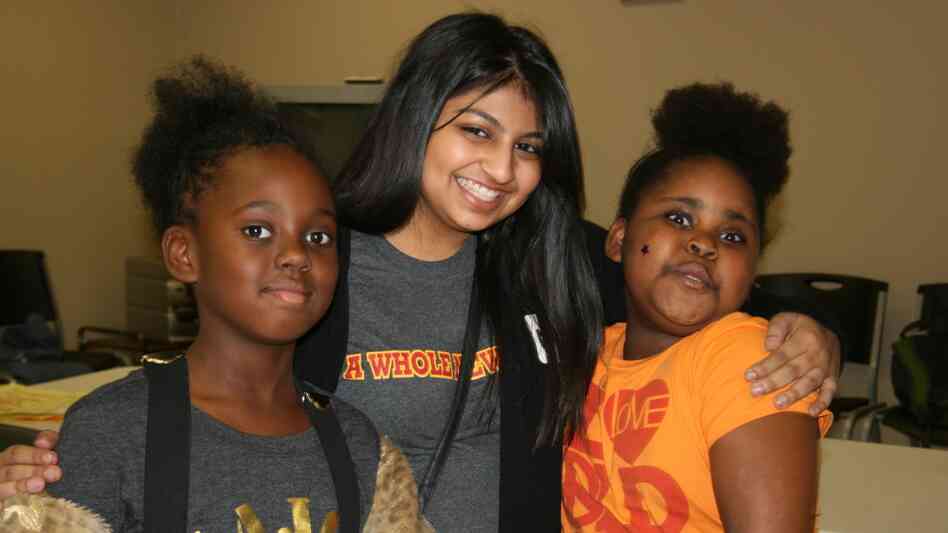 Austin College student Naureen Dharani, center, with new friends at an afterschool program.