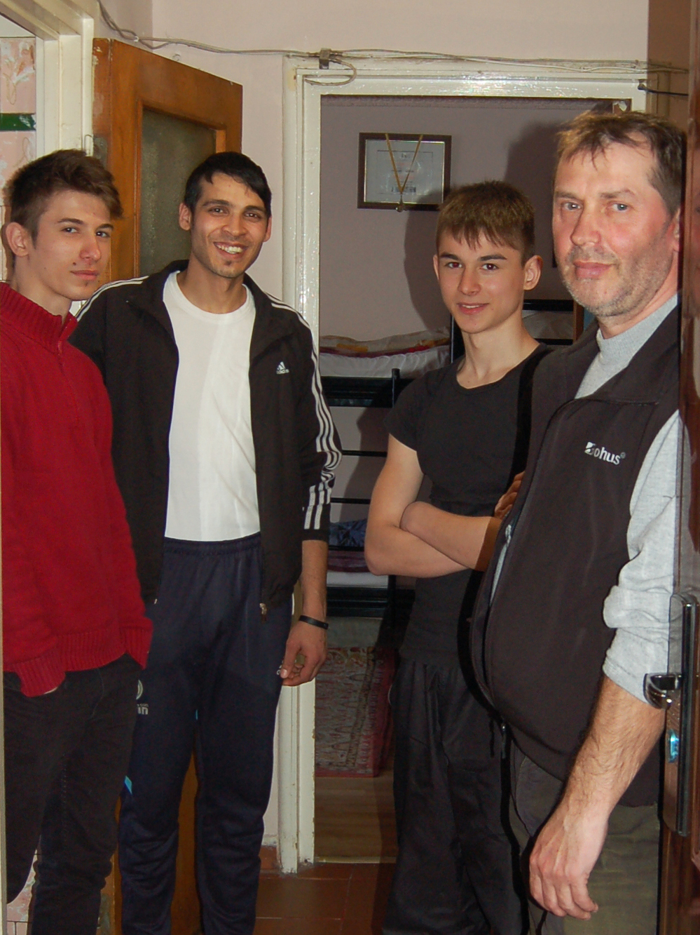 In Romania, a country with many abandoned children, Florin Grosuleac (right) has taken care of more than 60 boys over the past 13 years in his small apartment in Bucharest. Three of the boys currently living with him are (left to right) Emanuel, Dragos and Samuel.