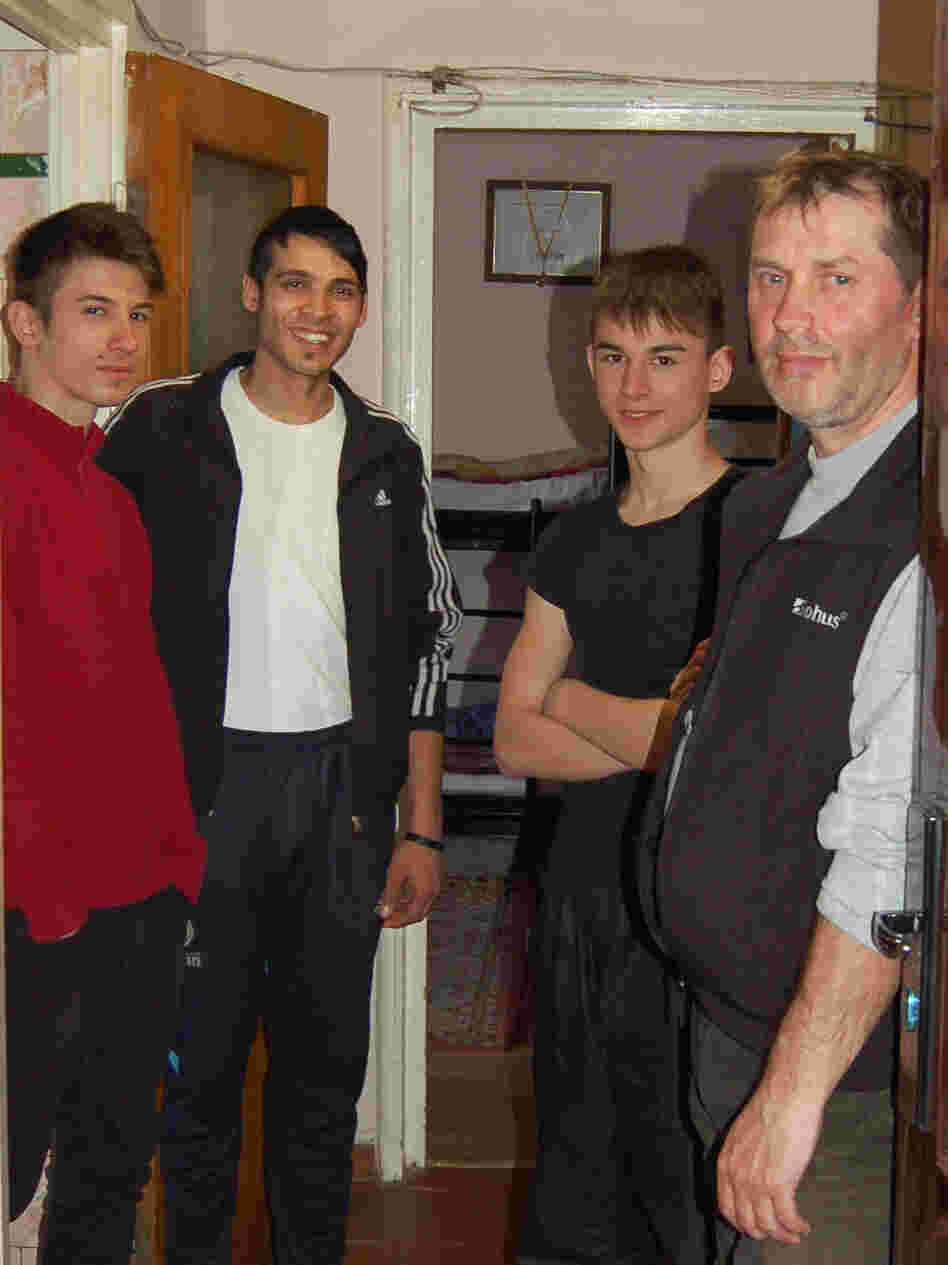 In Romania, a country with many abandoned children, Florin Grosuleac (right) has taken care of more than 60 boys over the past 13 years in his small apartment in Bucharest. Three of the boys currently living with him are (left to right) Emanuel, Dragos and Samuel.