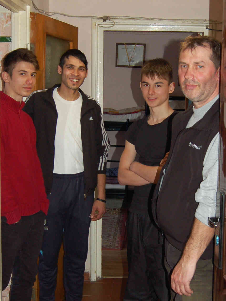 In Romania, a country with many abandoned children, Florin Grosuleac (right) has taken care of more than 60 boys over the past 13 years in his small apartment in Bucharest. Three of the boys currently living with him are (left to right) Emanuel, Dragos and Samuel.
