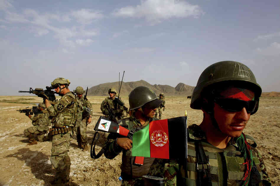 Afghan soldiers (right) patrol with U.S. troops in the Panjwai district of southern Afghanistan in May. The two armies have been working together for years, but Afghan attacks against U.S. and NATO forces have been rising recently.