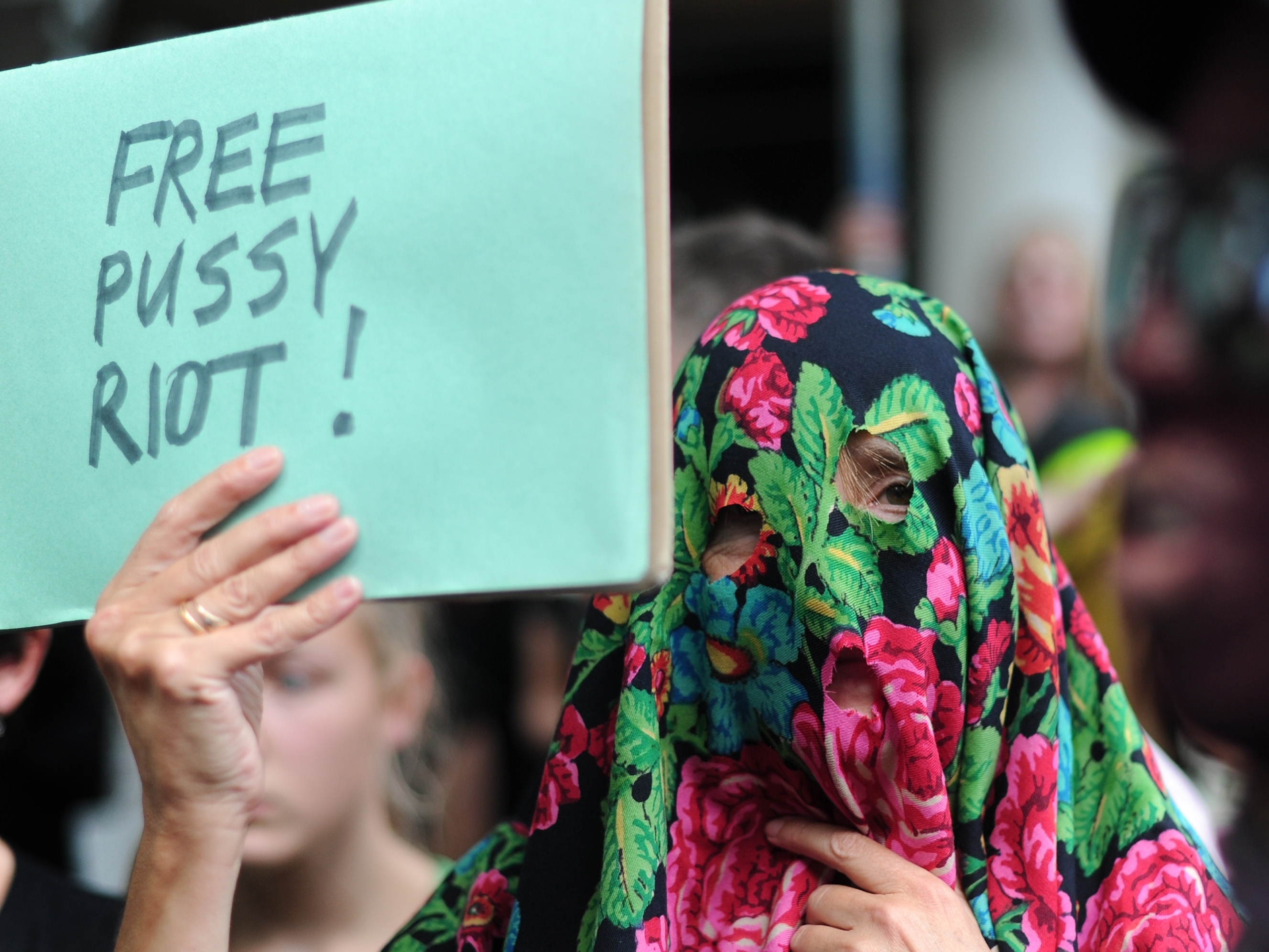 Masked supporters of all-girl punk band 'Pussy Riot' protest near the Russian embassy in London on August 17.