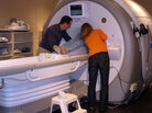Dr. Amit Etkin and a research assistant help a participant into the bore of the MRI. Dr. Amit Etkin and a research assistant help a participant into the bore of the MRI.