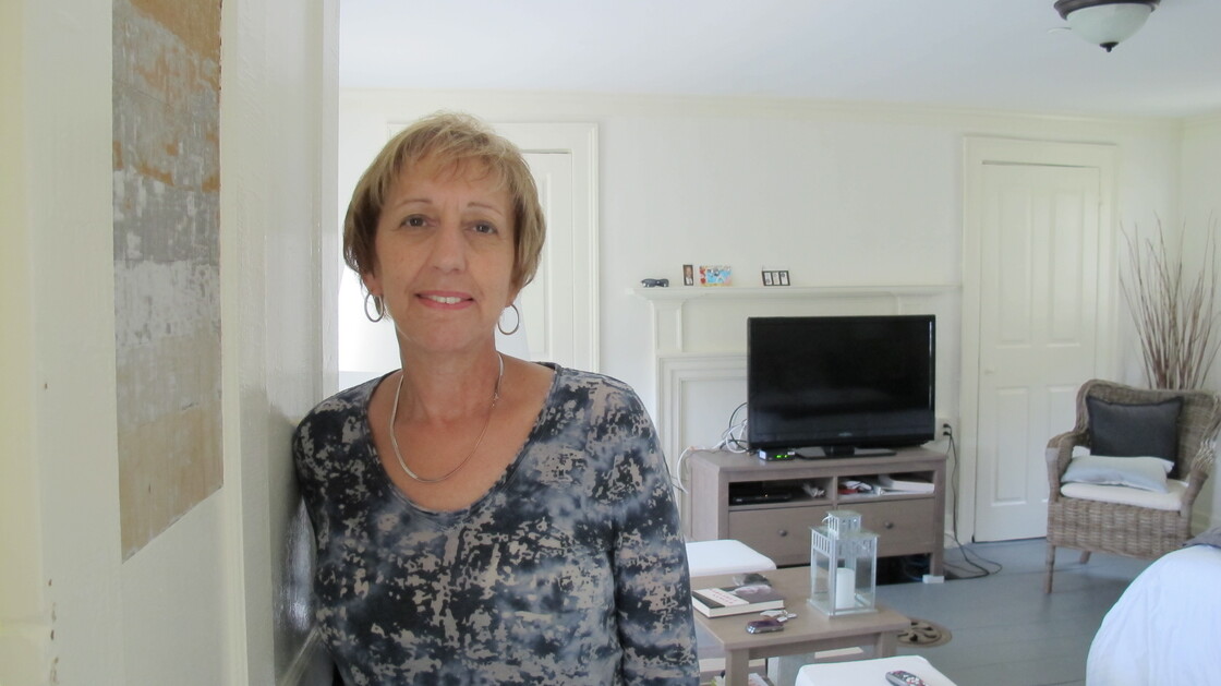 Eva Boice moved to Strawbery Banke from New York to be closer to her family. A retired social studies teacher, she appreciates the nuances of her new home, like the mismatched paint on her door panel. During renovations, contractors uncovered paint layers dating to the early 1800s.
