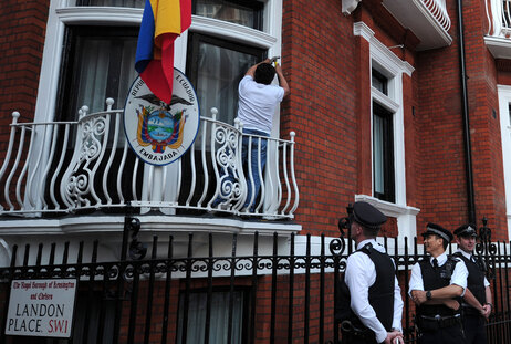 Police stand by near a balcony of the Ecuadorian embassy in London on Sunday. Police stand by near a balcony of the Ecuadorian embassy in London on Sunday.