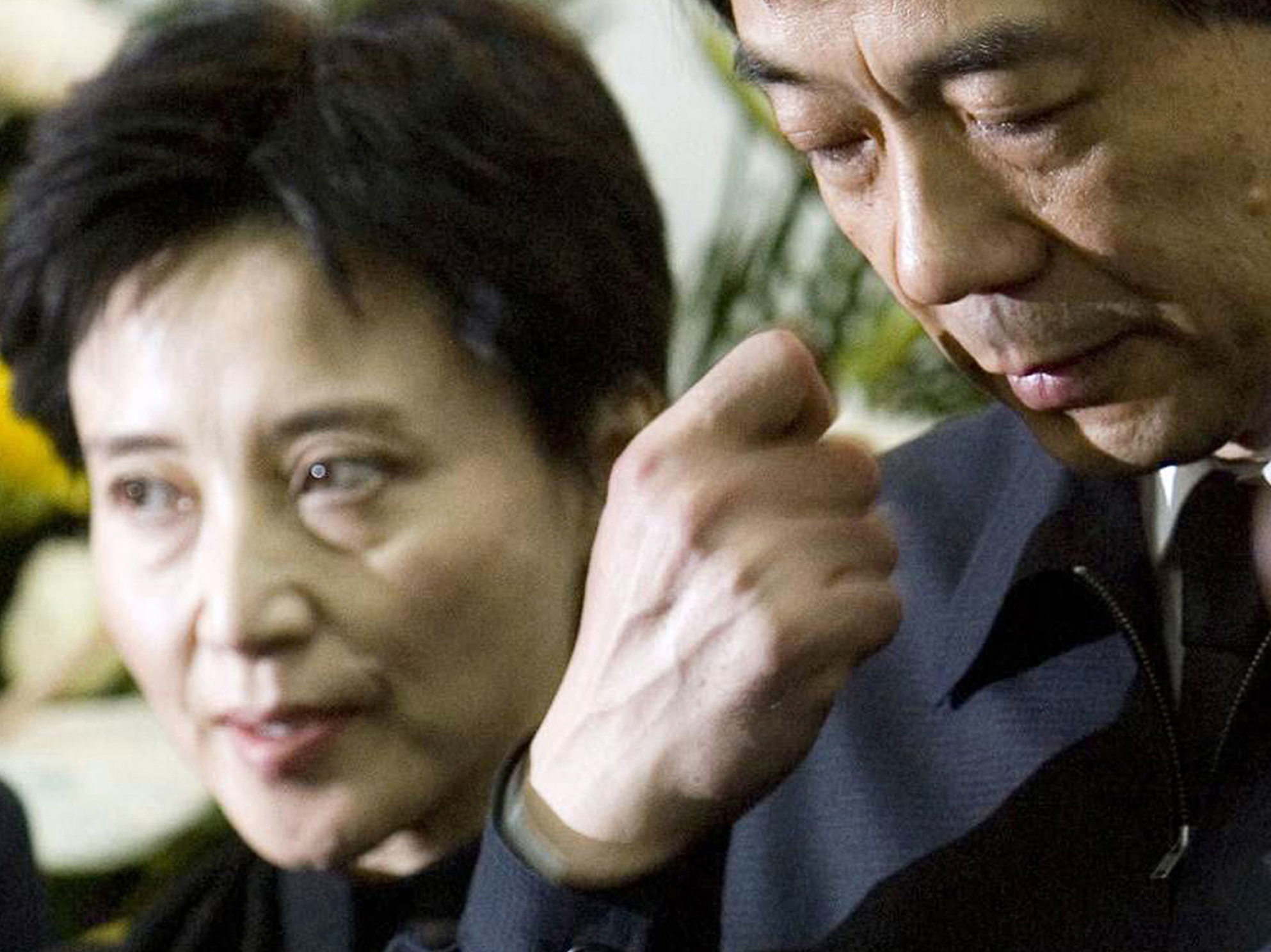 In this Jan. 17, 2007, photo, Gu Kailai, left, and her husband, Bo Xilai, attend a memorial ceremony for Bo's father. Gu was given a suspended death sentence Monday after confessing to killing a British businessman by poisoning him with cyanide.